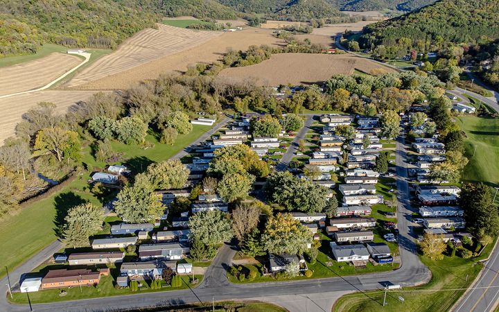 Aerial view of a mobile home park among farm fields and trees