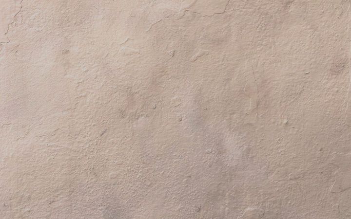 Close view of a lightly textured beige wall surface